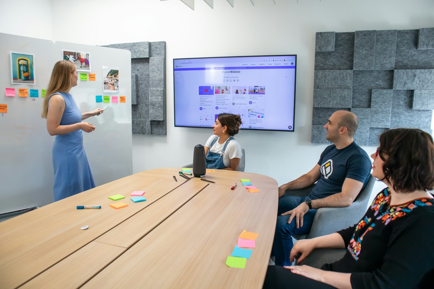 Team brainstorming ideas on a whiteboard with sticky notes.